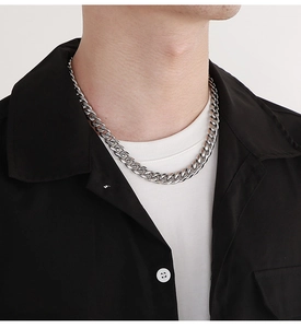Detailed view of silver 10mm beveled Cuban link chain necklace on a male model