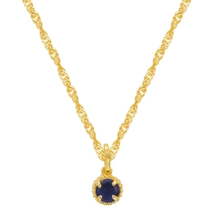Close-up of December birthstone necklace with deep blue gem and gold-plated chain