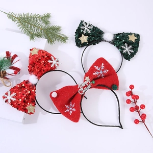 Three sequined Christmas bow headbands with Merry Christmas metal decor on white background