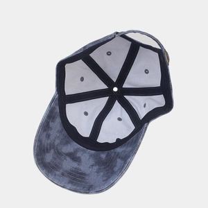 Inside view of washed tie-dye baseball cap showing 6-panel structure and reinforced tape