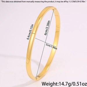 Detail view of oval gold bangle with measurements 6cm by 5cm inner diameter and 0.4cm width