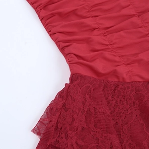 Close-up of red ruched fabric texture and delicate floral lace stitching detail