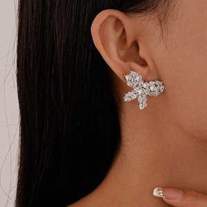 Close-up of sweet butterfly stud earrings with sparkling zircons on model ear