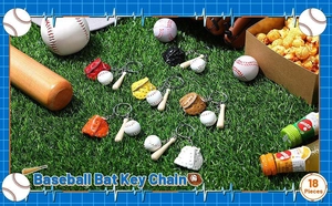 Close-up of baseball keychain sets with wooden bat and leather glove on grass