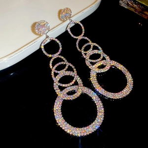 Detailed macro view of cascading silver tassel earrings with shimmering crystals