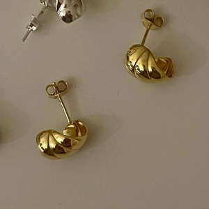 925 Sterling Silver croissant stud earrings in gold and silver finish on beige background