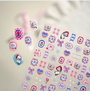 Macro shot of 3D embossed nail stickers featuring cute hand-drawn cats and floral patterns