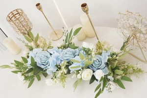 Detailed close-up of blue roses and white silk flowers in a long wedding floral runner