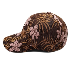 Close-up of lace embroidered baseball cap with floral pattern and mesh texture