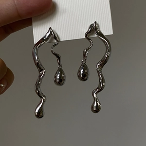 Asymmetric silver snake and water drop earrings with a modern liquid metal design