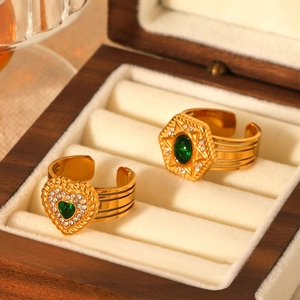 Golden stainless steel open rings with green heart and star zircons in jewelry box