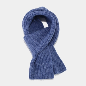 Detail of indigo blue ribbed knit scarf showing soft texture and thick material quality