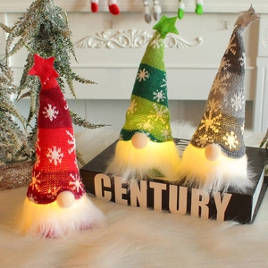 Lighted Christmas Gnomes in Red, Green, and Grey knits on a cozy indoor holiday display