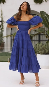 Detail of off-shoulder ruched bodice and puff sleeves on a blue summer maxi dress