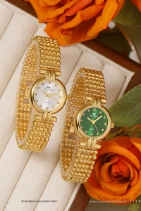 Close-up of luxury gold beaded quartz watches with green and white rhinestone dials