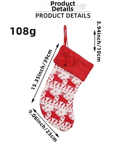 Close-up of knitted reindeer Christmas stocking with size measurements and pom-poms