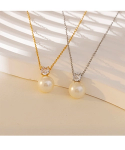 Detail of round pearl and zircon pendant necklaces in gold and silver finishes