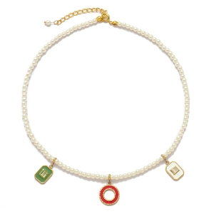 Macro detail of pearl necklace featuring colorful enamel square and round pendants