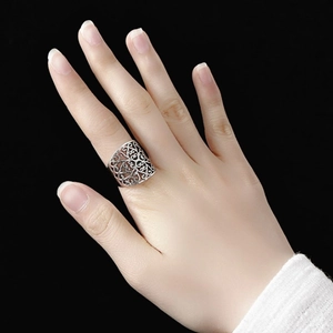 Vintage hollow cloud pattern wide band ring in silver finish worn on finger