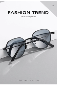 Close-up of retro black metal frame sunglasses with dark gray lenses on a white pedestal