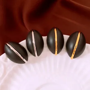 French vintage oval wood-textured earrings in matte black with gold and silver accents