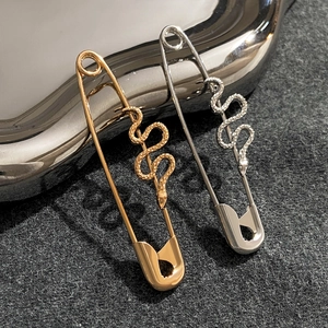 Orecchini a forma di serpente e spilla da balia in oro e argento con dettagli a scaglie
