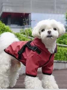 Macro detail of waterproof dog raincoat with integrated harness on small dog