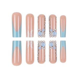 Blue press-on nails with 3D resin flowers, pearls, and silver glitter in long coffin shape