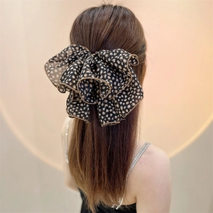 Leopard print mesh bow hair clip on model's hair, stylish chiffon leopard hair accessory