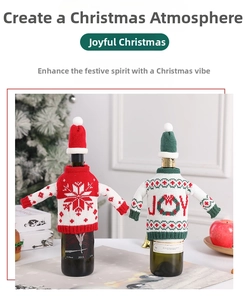 Detailed view of red snowflake and green JOY knitted wine bottle covers with mini hats