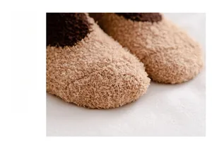 Close-up of thick beige and brown coral fleece socks with ultra-soft plush texture