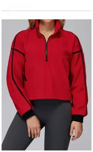Detail of red fleece jacket featuring high collar, half-zipper and black side stripes