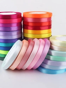 Macro detail of multi-colored polyester satin ribbons in rolls for gift wrapping