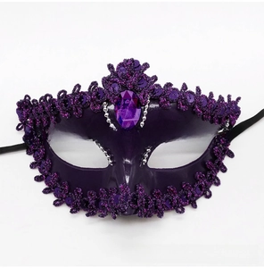 Detail of purple masquerade mask with teardrop gemstone and glitter lace edging