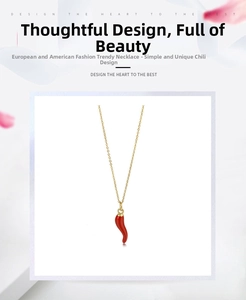 Detailed close-up of a vibrant red chili pendant on a minimalist gold-plated necklace chain