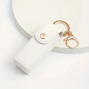 Detail view of white PU leather lipstick mini bag with premium gold keychain clasp