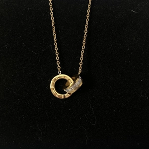 Gold double-interlocking ring necklace with Roman numerals and sparkling cubic zirconia