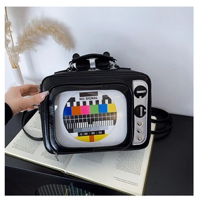 Macro view of retro TV shaped crossbody bag featuring a colorful screen and silver knobs