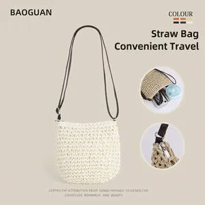 Straw woven tote bag for women featuring crochet texture and brown shoulder strap