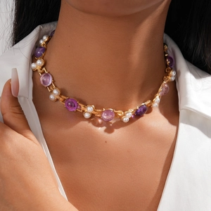 Detail shot of vintage choker necklace with purple stones and pearls on neck