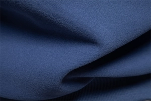 Macro shot of high-quality blue knitted fabric texture showing fine weave details