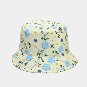 Détail du chapeau beige avec motifs floraux bleus et coutures renforcées du bord