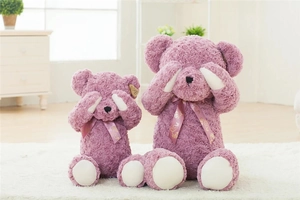 Detail of two purple rose-textured plush teddy bears in shy pose with floral ribbons