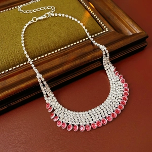 Macro view of multi-layer fringe necklace with silver chains and red oval gemstones