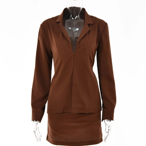 Detail view of brown long sleeve V-neck cardigan and high waist mini skirt on model