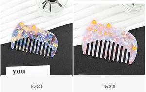 Close-up of cute acetate cat-shaped hair combs in purple and pink floral patterns