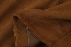 Detailed macro view of dark brown faux suede fabric with soft matching lining