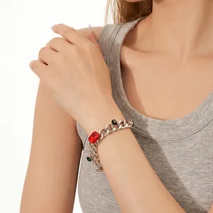 Silver thick chain bracelet with colorful gemstones on a model wrist for daily wear