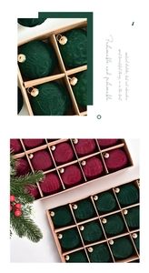 Close-up of dark green and wine red velvet Christmas ornaments with gold caps in a box