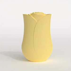 Detail showing a rose bud shaped light yellow silicone face ice roller with max logo